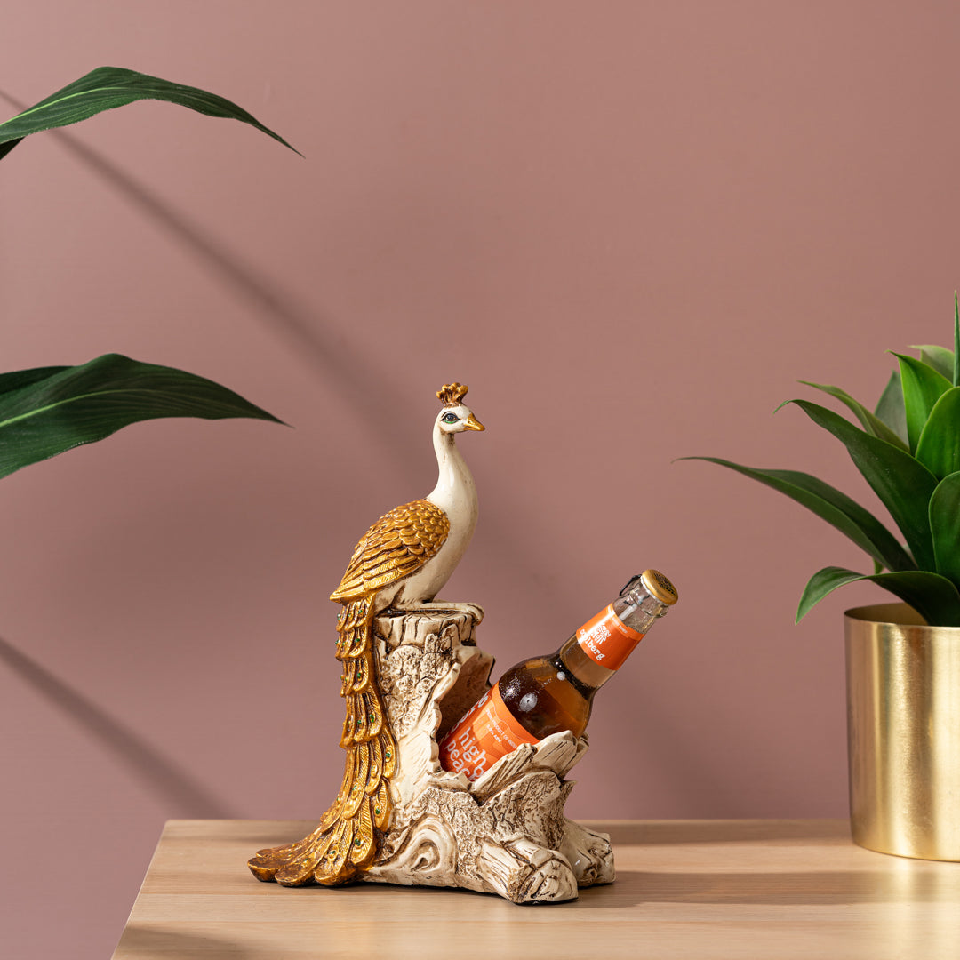 a bird figurine sitting on top of a table next to a plant