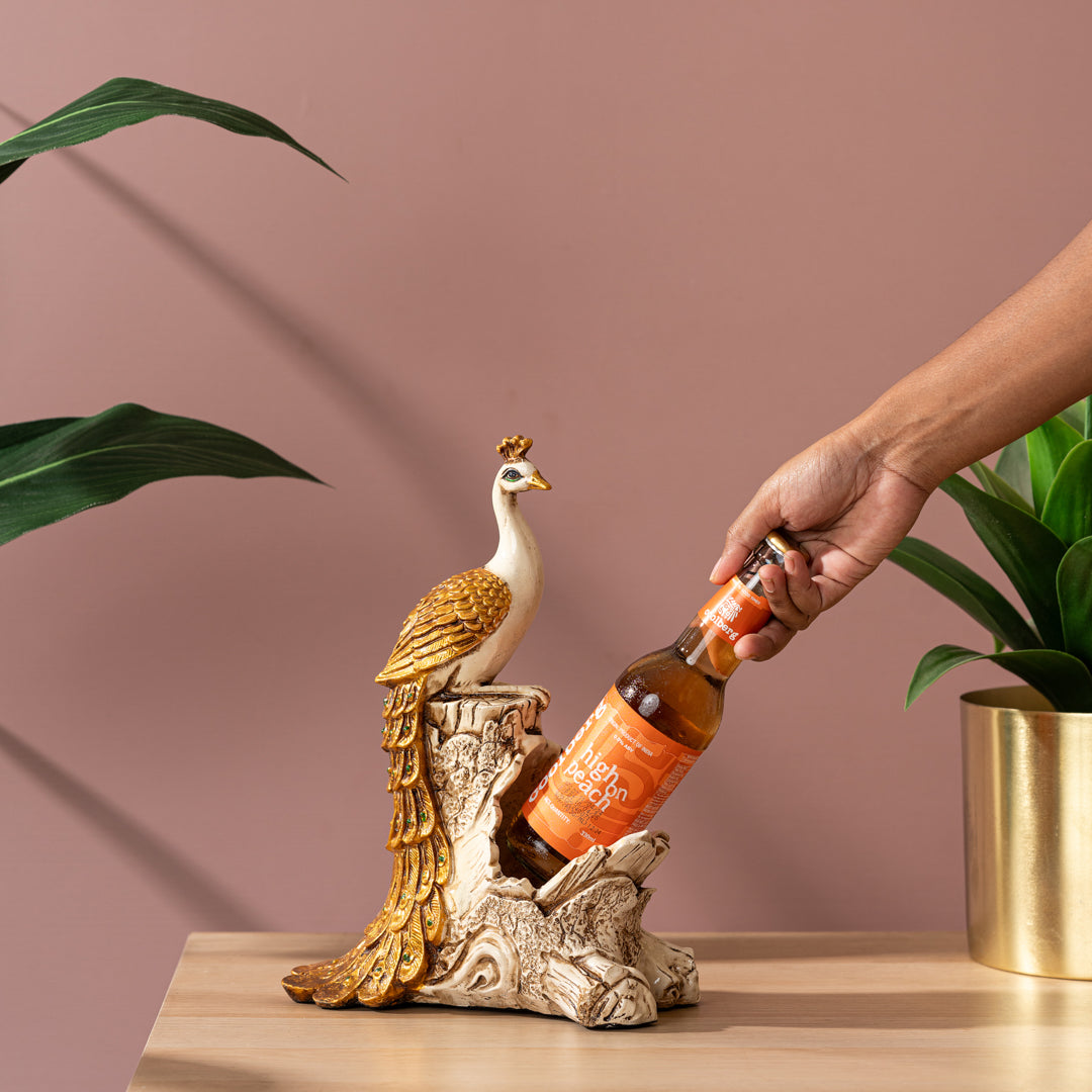 a person pouring a bottle of beer into a bird statue