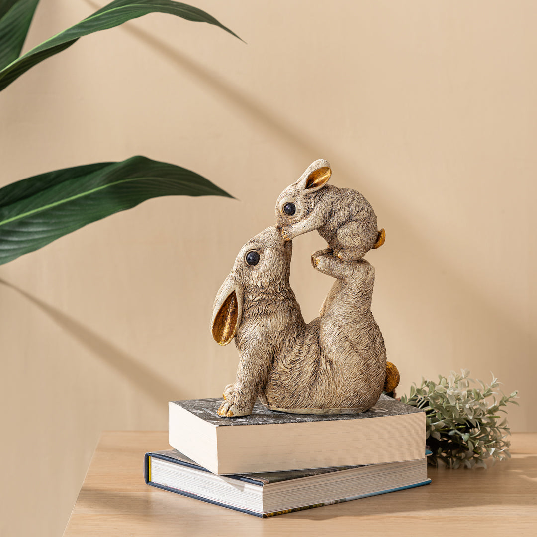 a couple of rabbits sitting on top of a book