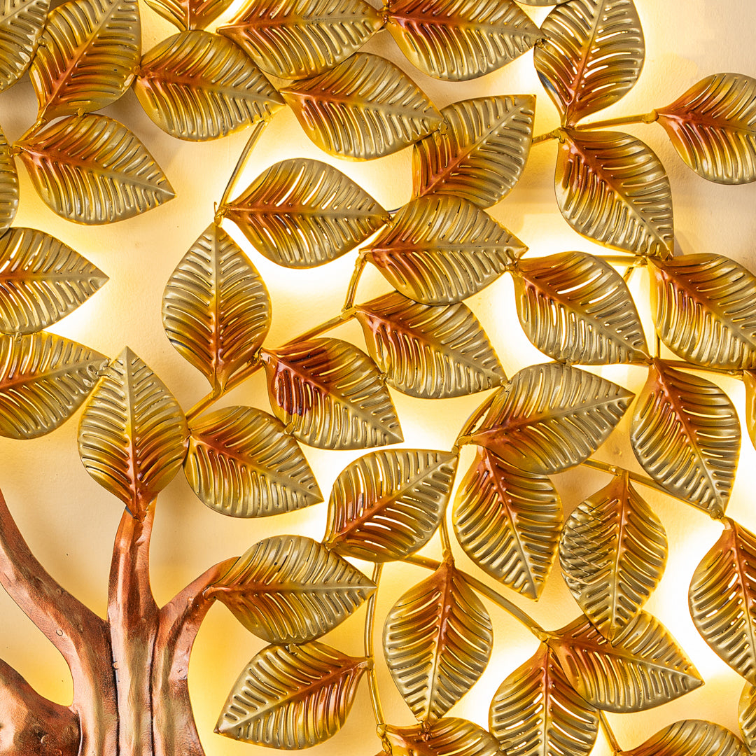 a golden sculpture of a tree with leaves on it