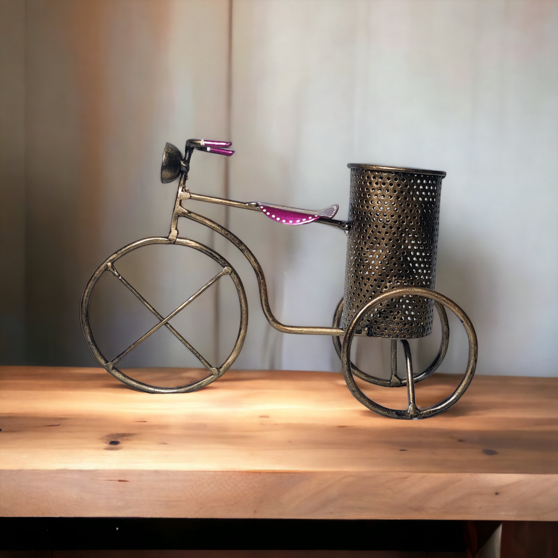 a metal sculpture of a bicycle on a wooden table